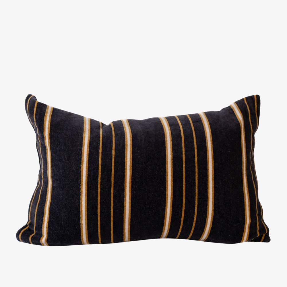 Black pillow with white and brown stripes on a white background