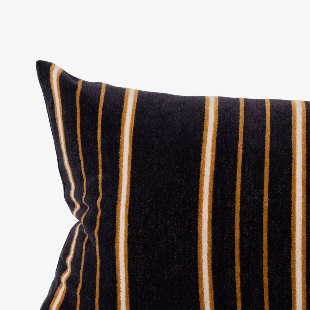Black pillow with white and brown stripes on a white background
