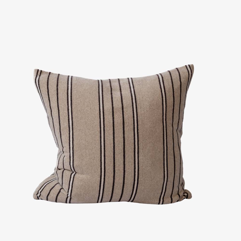 Beige pillow with black and white stripes on a white background