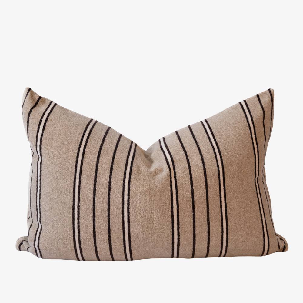 Beige pillow with black stripes on a white background