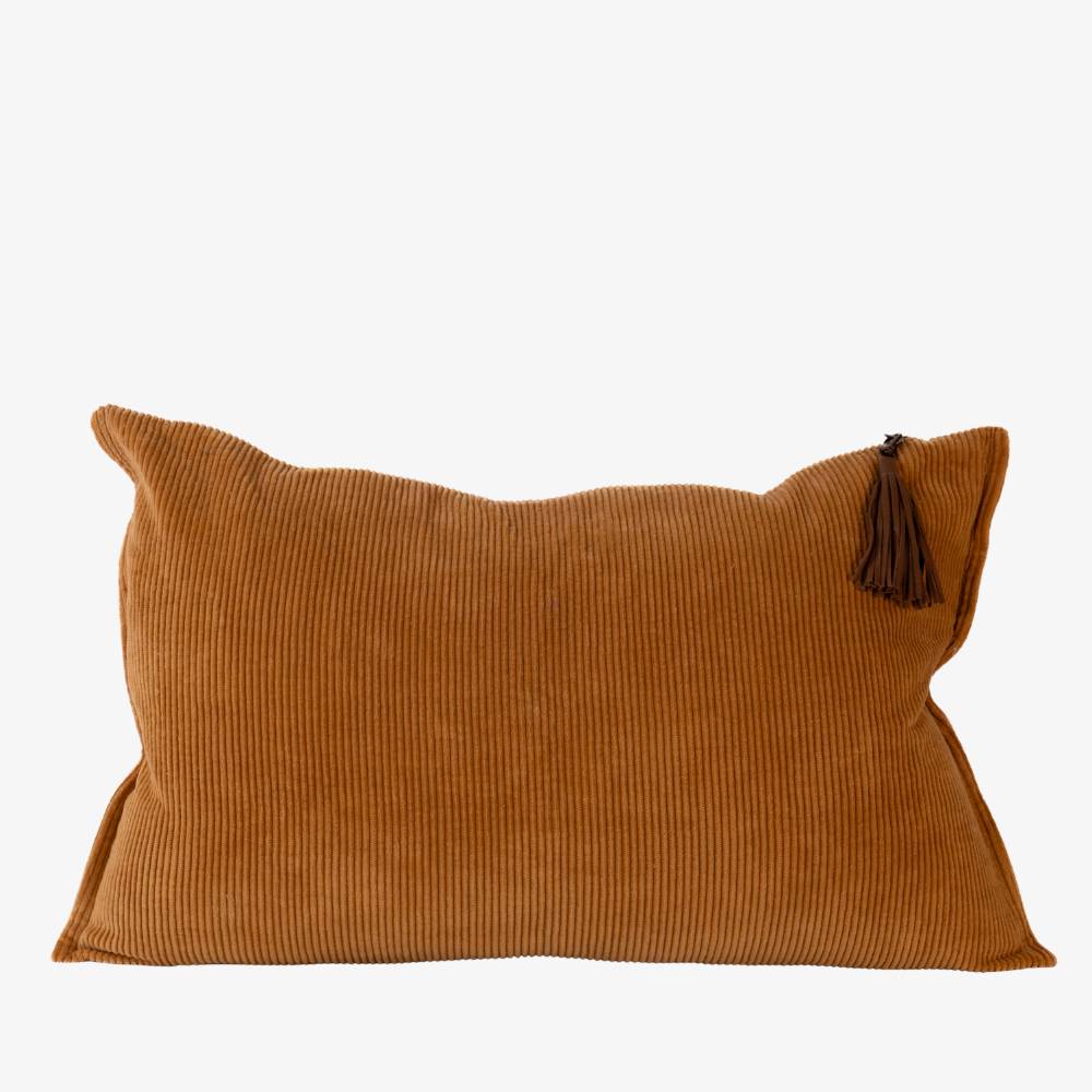 Brown corduroy pillow with a tassel on a white background
