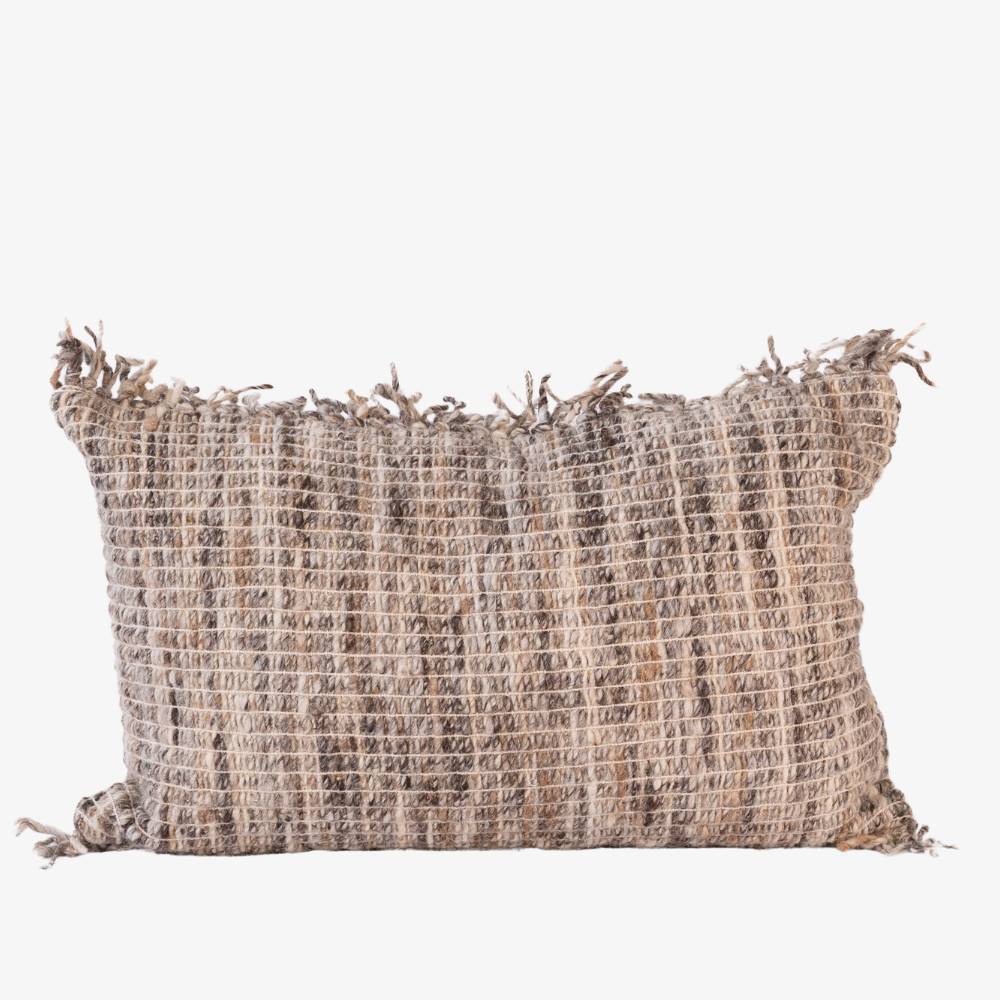 Textured pillow with tassels on a white background