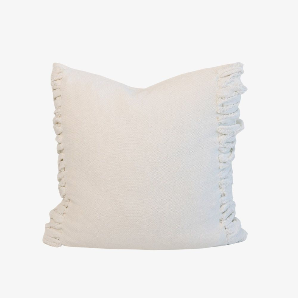 White pillow with fringe detail