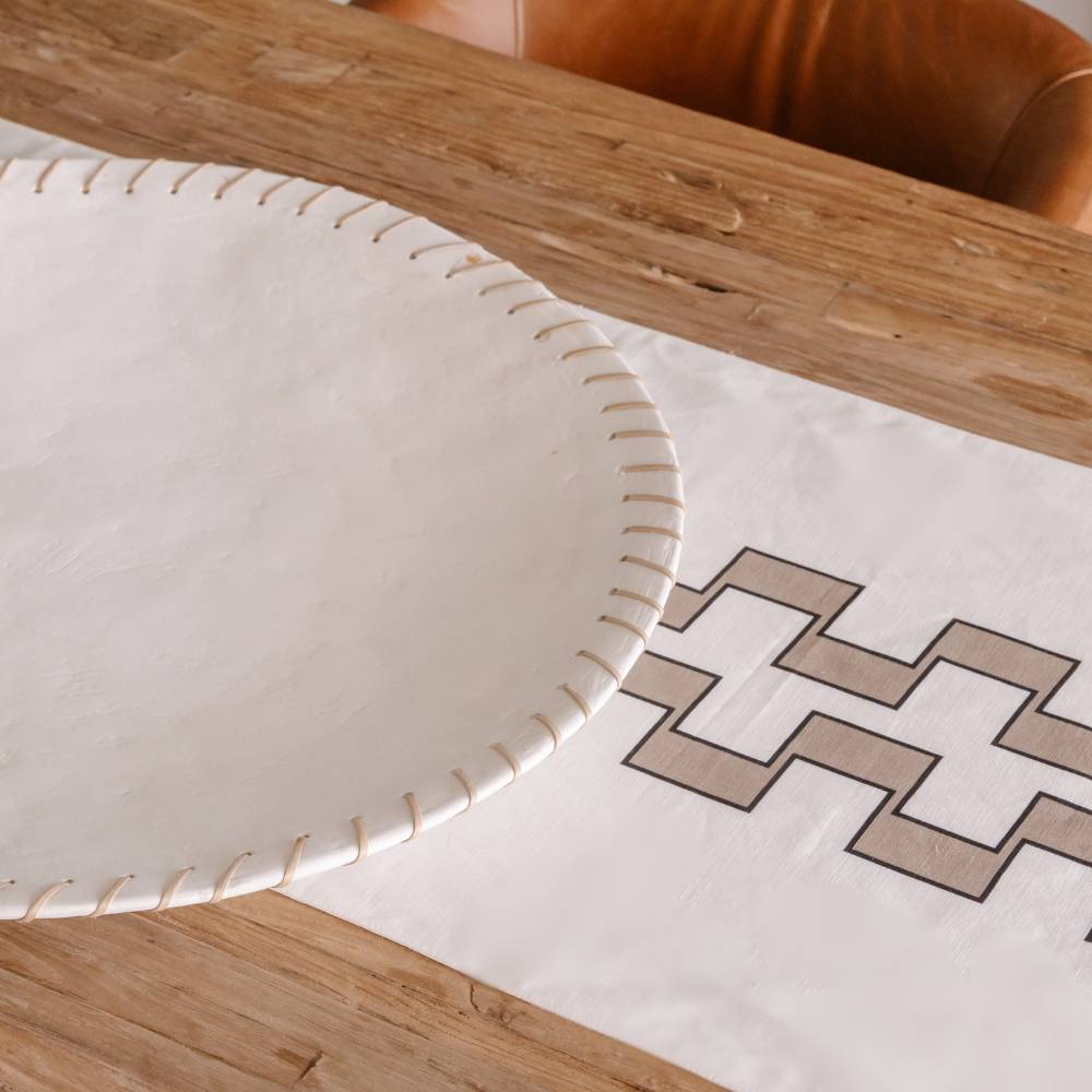 Close-up of a decorative plate with geometric pattern on a wooden surface