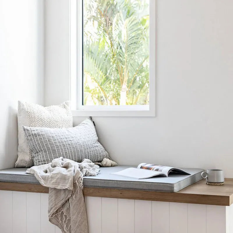 window seat perfect for reading styled with linen cushions and throws