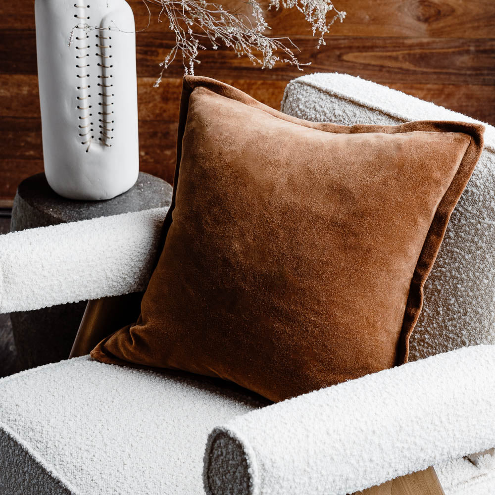 Evelyn velvet cushion in nutmeg on chair