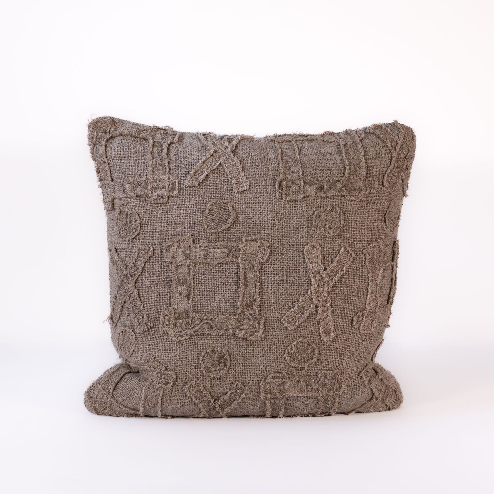 Textured pillow with geometric pattern on a white background