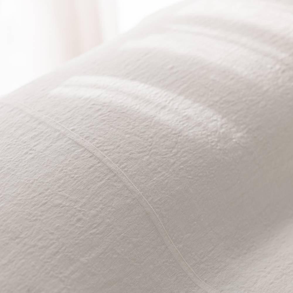 Off-White Luca Bed Cover styled over bed pillows