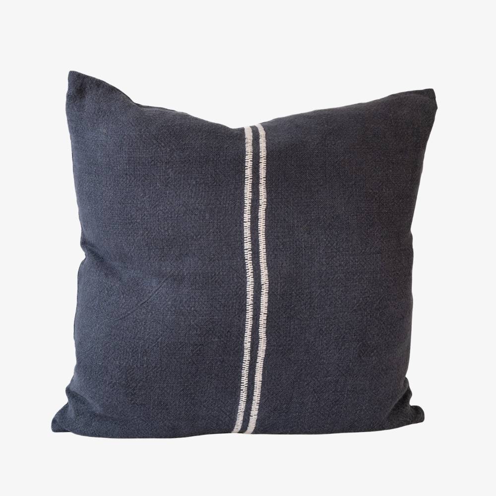 Dark blue pillow with a white stripe on a light gray background