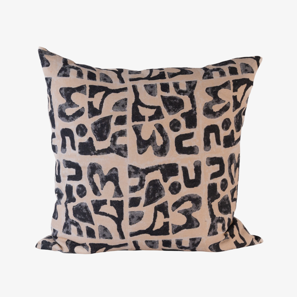 Decorative pillow with black abstract pattern on beige background