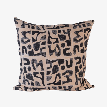 Decorative pillow with black abstract pattern on beige background