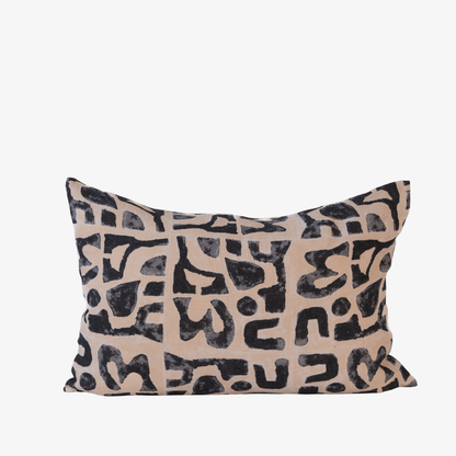 Decorative pillow with black abstract pattern on beige background