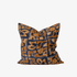 Decorative pillow with brown and blue pattern on a white background