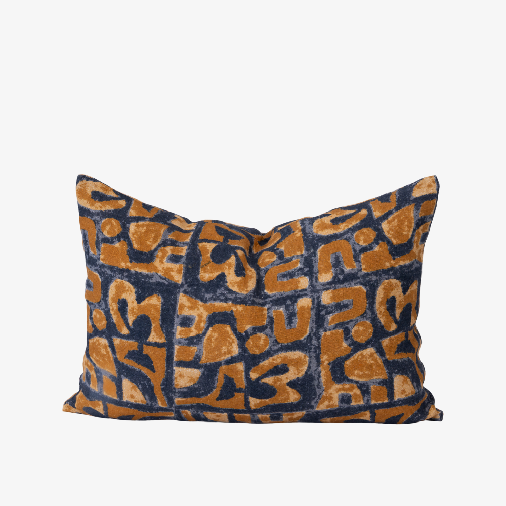 Decorative pillow with blue and orange geometric pattern on a white background