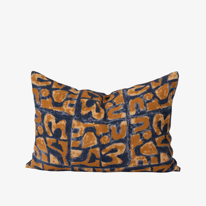 Decorative pillow with blue and orange geometric pattern on a white background