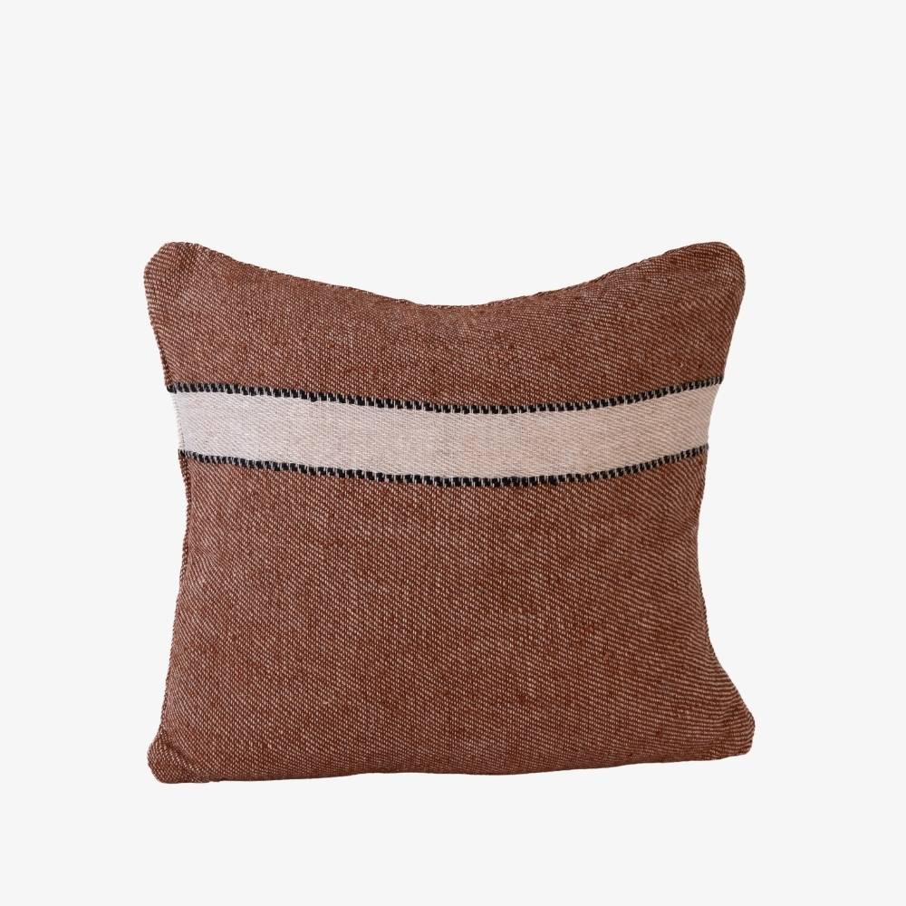 Brown pillow with a white stripe on a white background