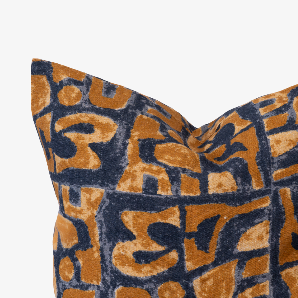 Decorative pillow with a blue and orange geometric pattern on a white background