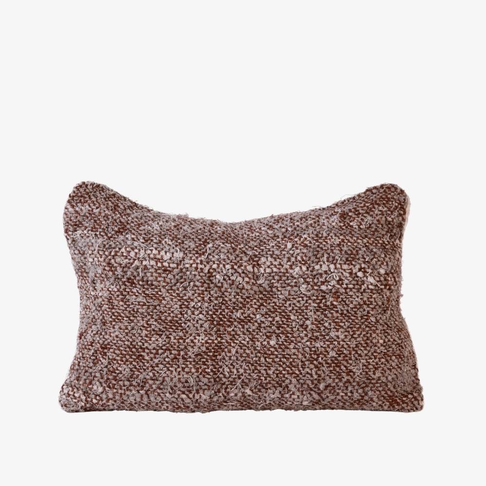 Textured brown pillow on a white background