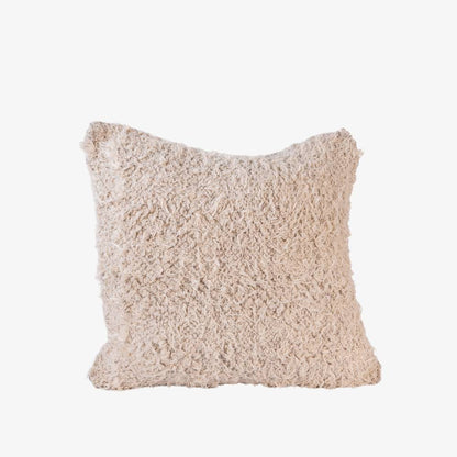 Textured beige pillow on a light gray background