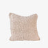 Textured beige pillow on a light gray background