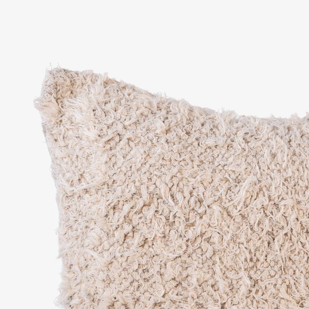 Beige textured pillow on a white background