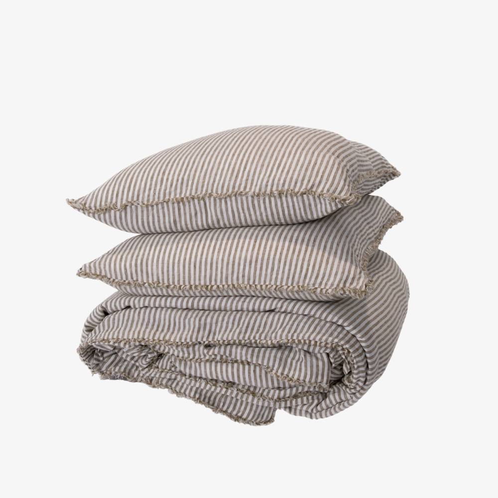 Folded striped bedding set on a white background