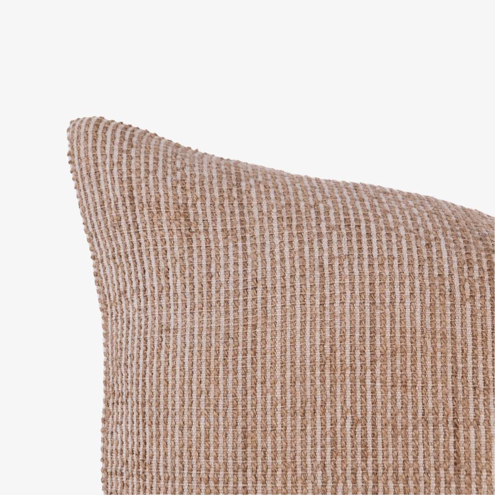 Textured beige pillow on a white background