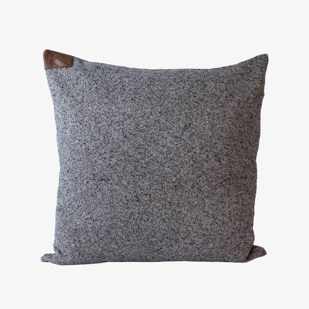 Gray textured pillow with a wooden back on a white background