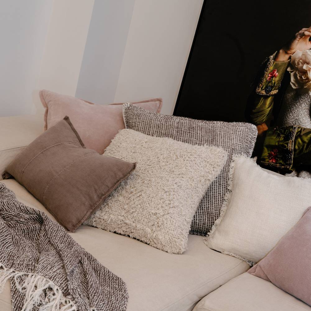 Decorative pillows on a sofa with a neutral color palette