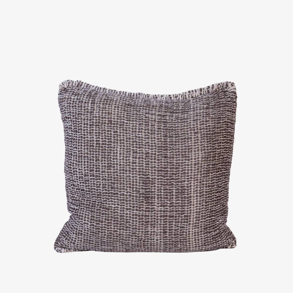 Textured pillow with a subtle pattern on a white background