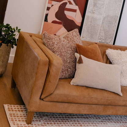 Brown sofa with decorative pillows in a living room setting