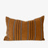 Striped pillow with brown, white and black pattern on a white background