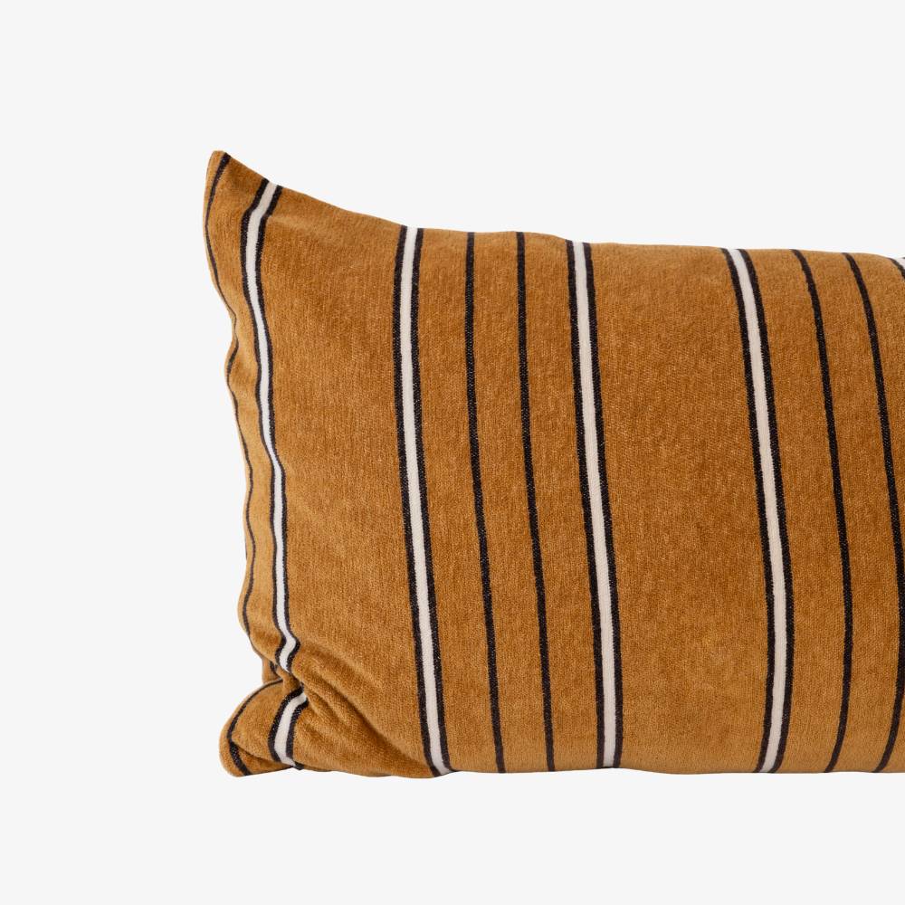Striped pillow with brown, black, and white pattern on a white background