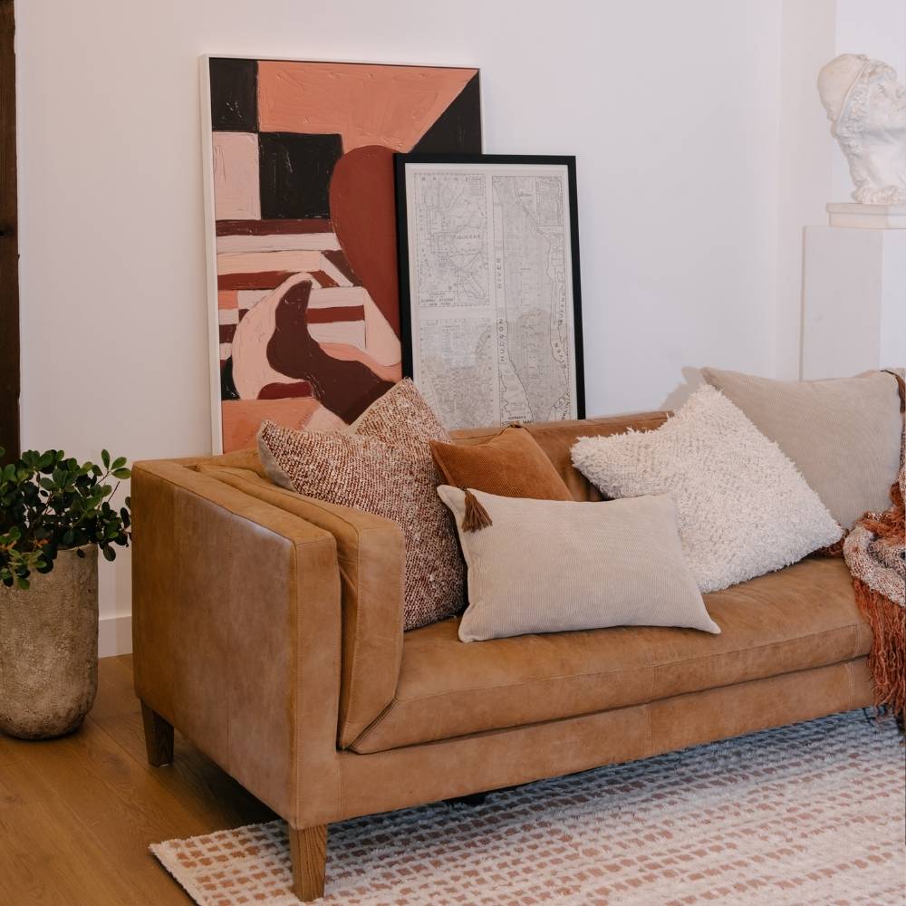 Brown sofa with decorative pillows in a living room setting