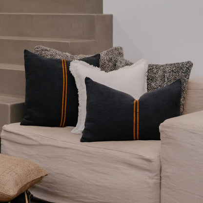 Decorative pillows on a beige sofa with a neutral background