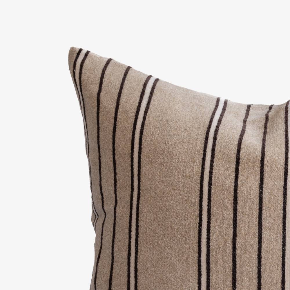 Beige pillow with black stripes on a white background