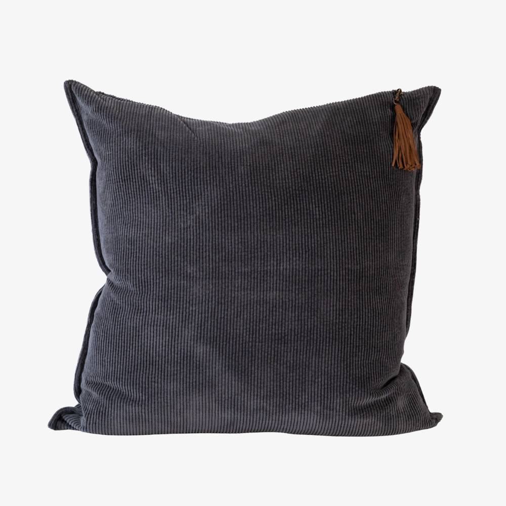 Dark blue pillow with a brown tassel on a white background
