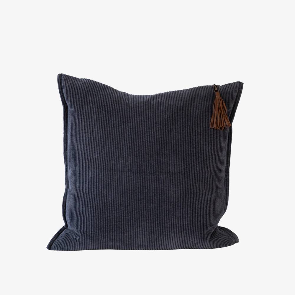 Dark blue pillow with a brown tassel on a white background