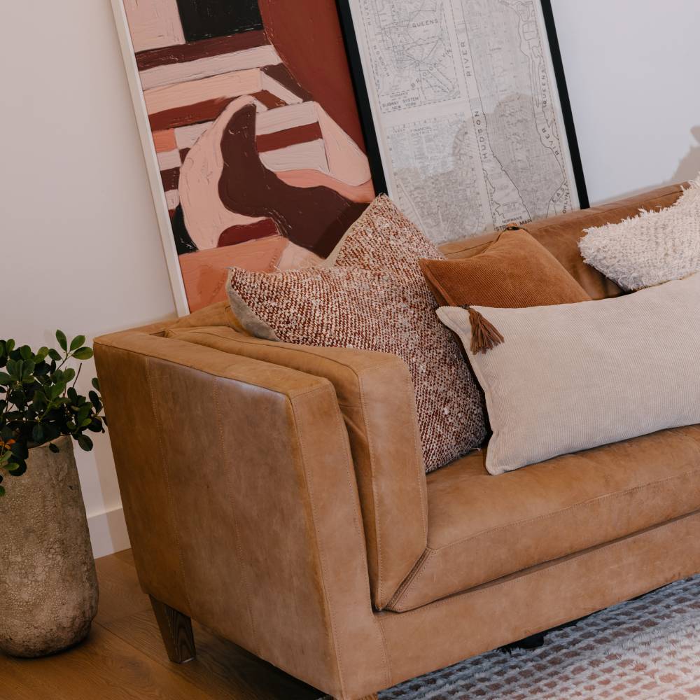 Brown sofa with decorative pillows in a living room setting