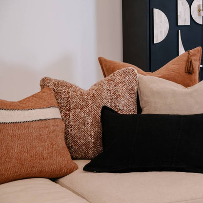 Decorative pillows on a sofa with a neutral background