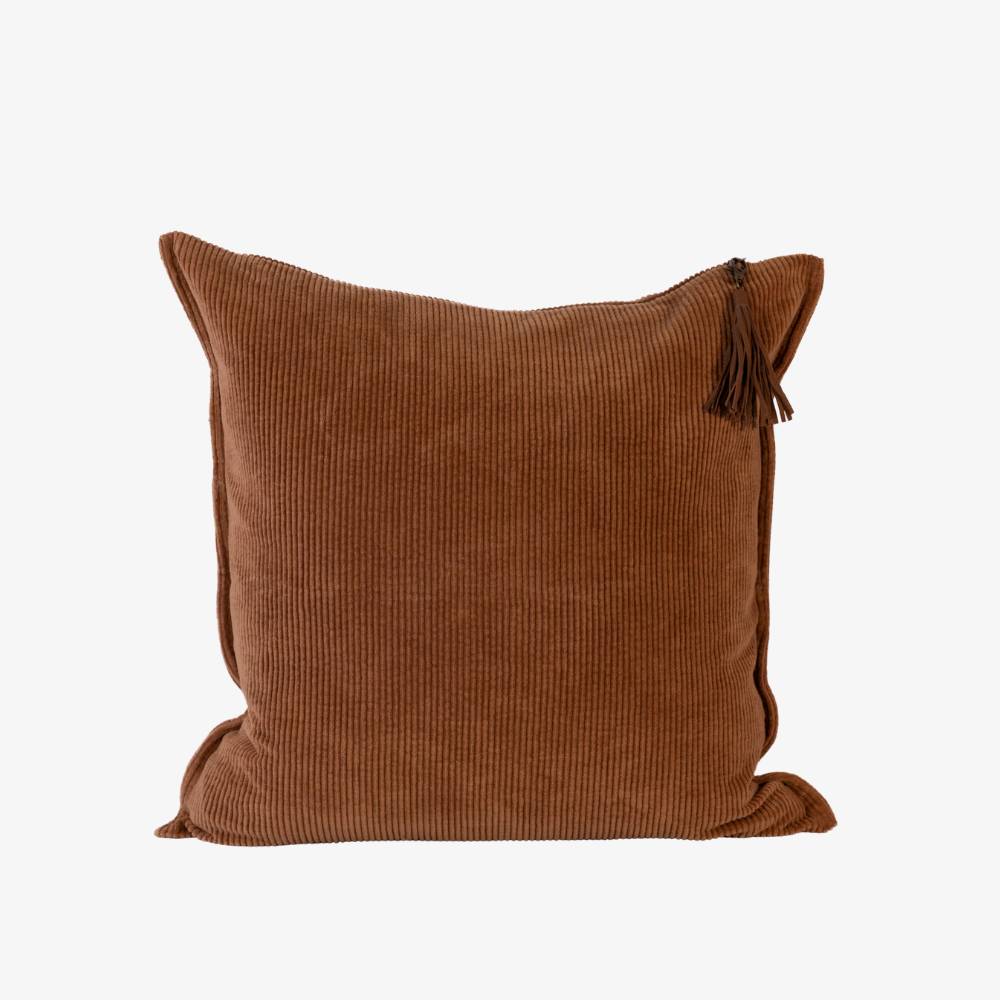 Brown textured pillow with a tassel on a white background