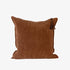 Brown textured pillow with a tassel on a white background