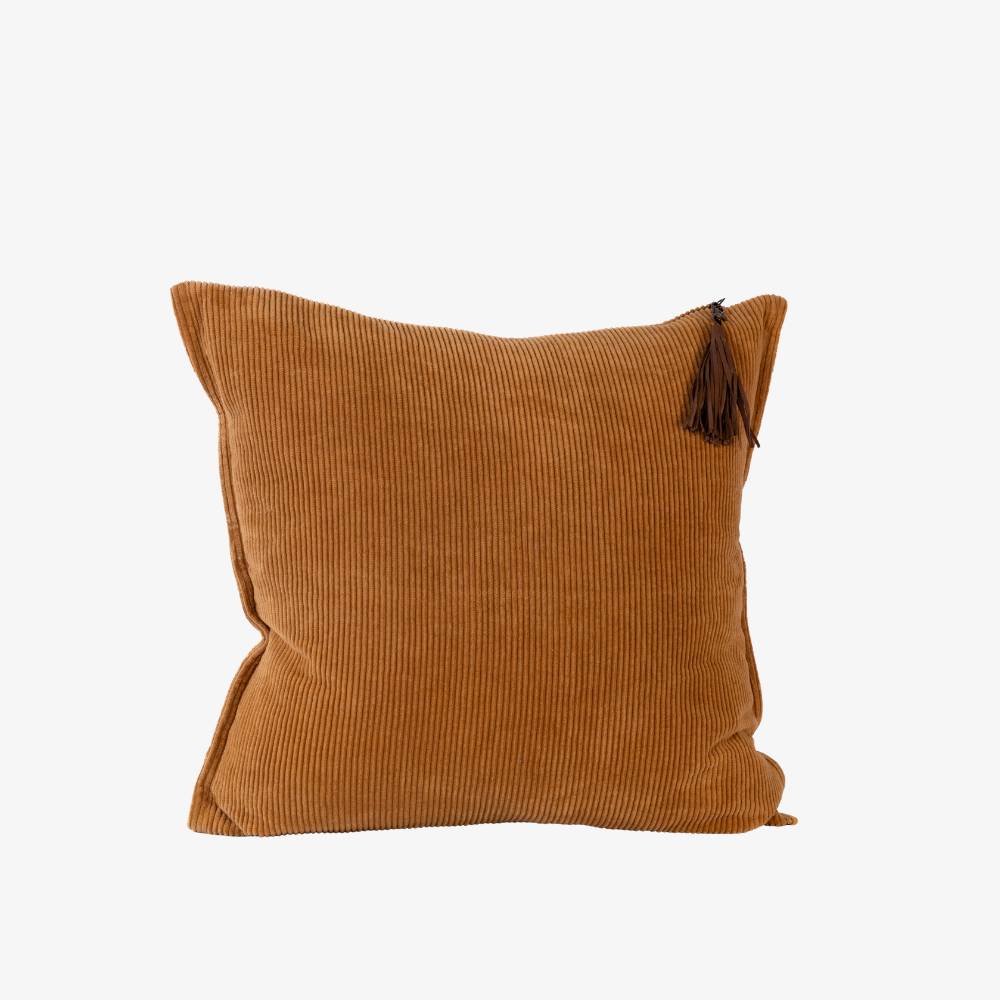 Brown corduroy pillow with a tassel on a white background