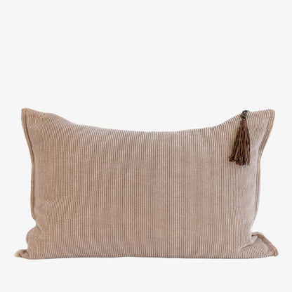 Beige pillow with a tassel on a white background