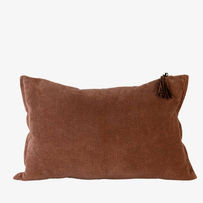 Brown textured pillow with a tassel on a white background