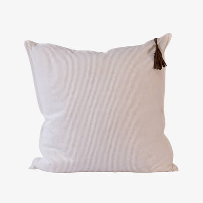 Beige pillow with a tassel on a white background