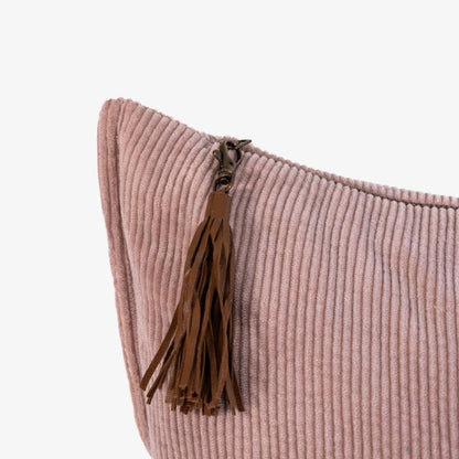 Pink pillow with a brown tassel on a white background