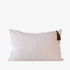 Beige pillow with a tassel on a white background