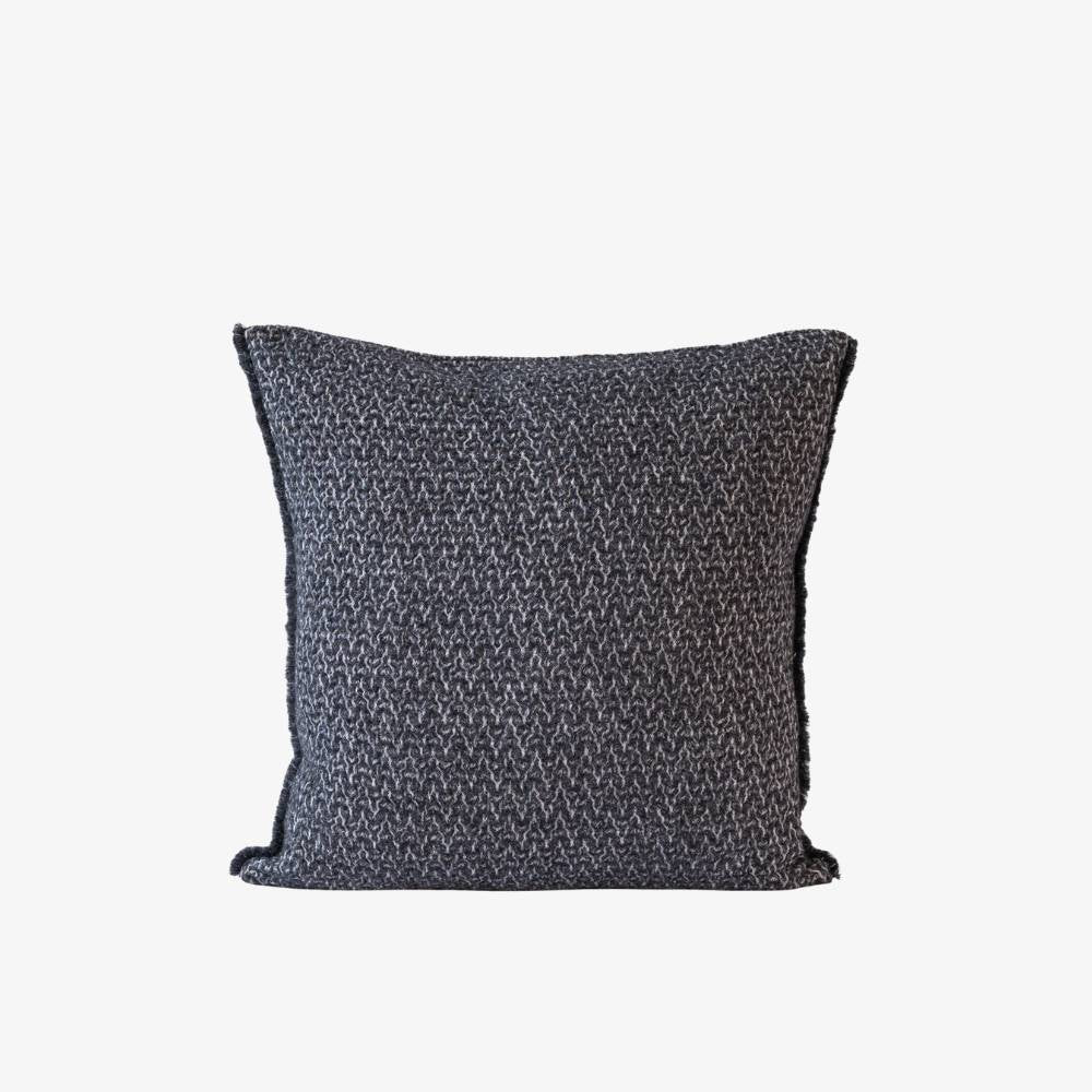 Textured dark gray pillow on a white background