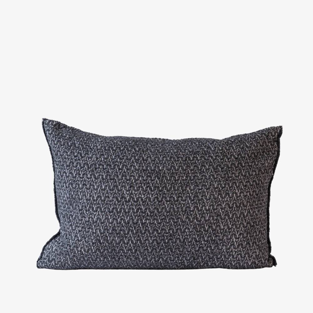 Textured dark gray pillow on a white background